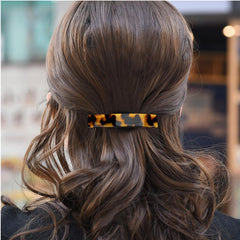 Fsmiling close-up of acetate tortoise pattern, highlights premium texture and shine