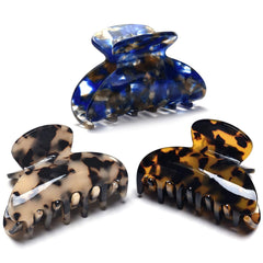 Fsmiling front view of three tortoise claw clips showing pattern and size benefit