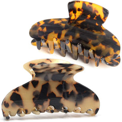 Fsmiling front view of two tortoise claw clips showing pattern and compact shape for styling