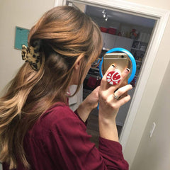 Fsmiling half-up hairstyle held by clip demonstrating easy everyday styling