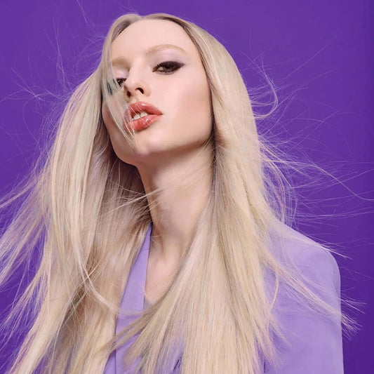 Fudge shampoo lather close-up on hair, shows violet tint restoring coolness