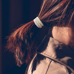 Funtopia hair ties beside a hand showing size and stretch for thick hair