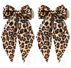 Furling Pompoms camel satin bow front packaging shows elegant camel shade and shape benefit