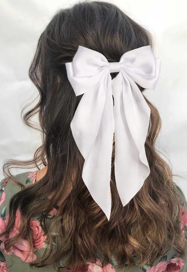 Furling Pompoms beside a ruler shows bow dimensions for confident sizing