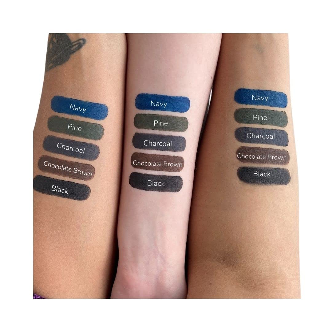 Gabriel Cosmetics navy eyeliner held in hand to show compact size and portability