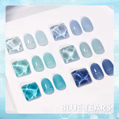 GAOY jelly blue manicure in a beach setting highlighting wearable, glassy seaside tones