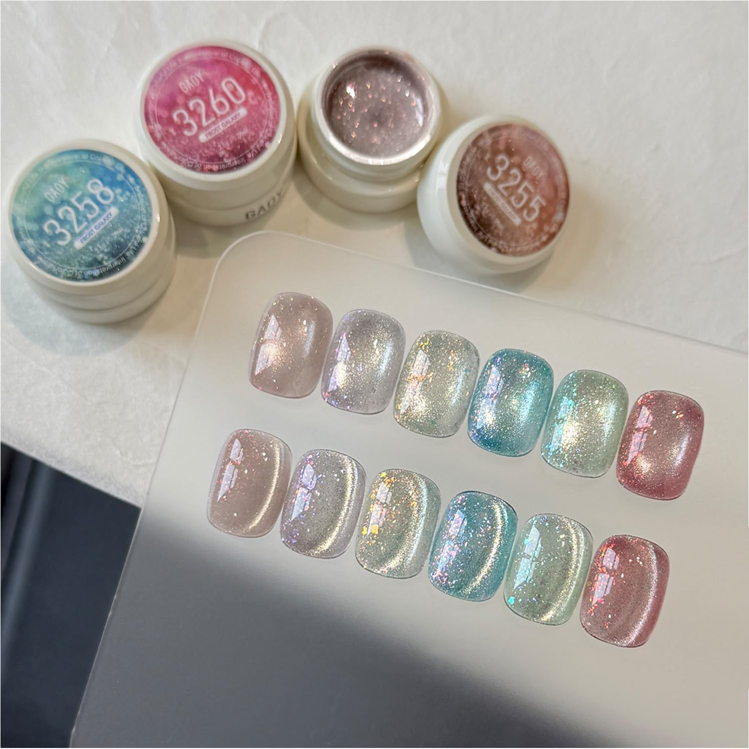 GAOY manicured hands wearing frost galaxy cat eye nails demonstrating salon finish