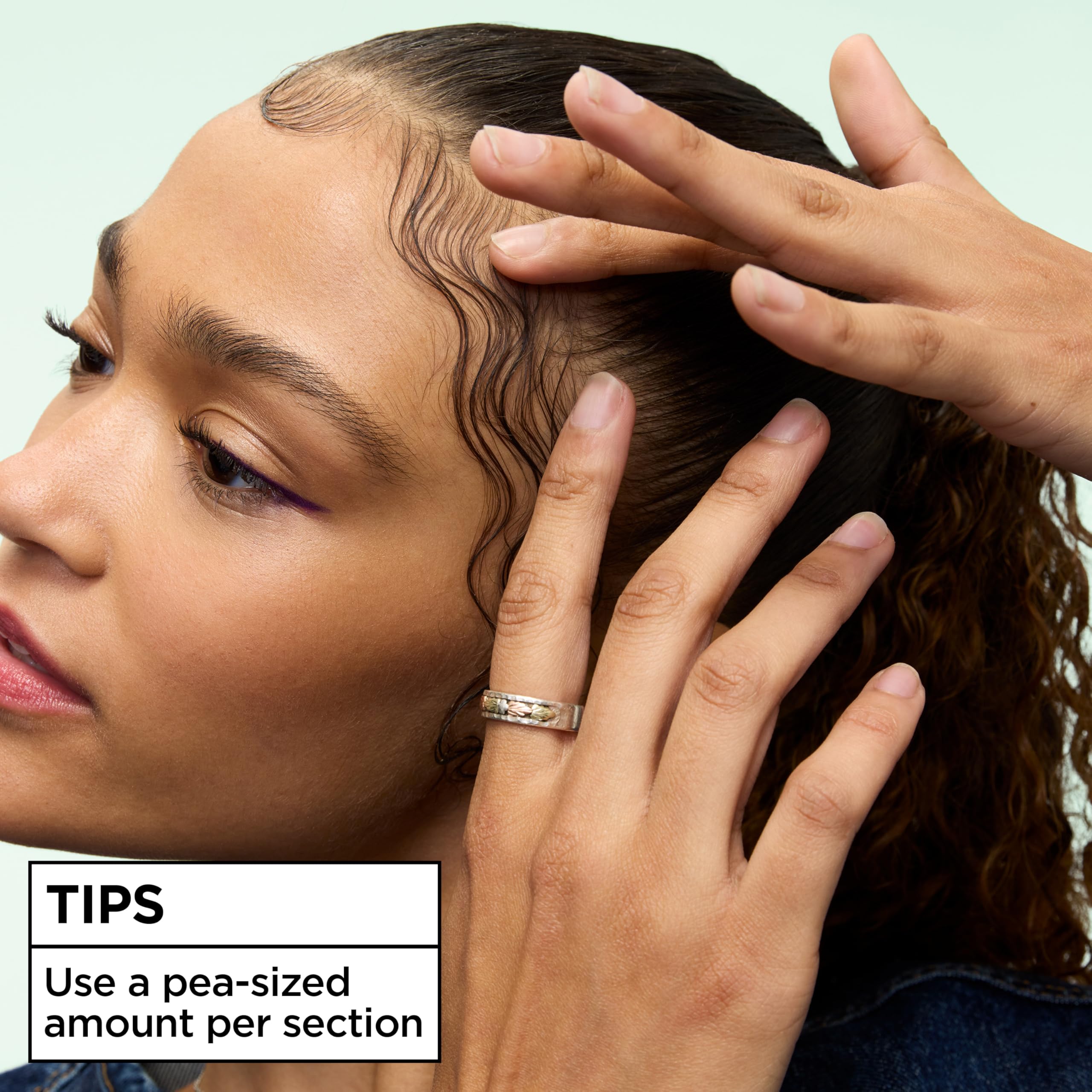 Garnier Fructis finger-coiling close-up creating defined tight coils