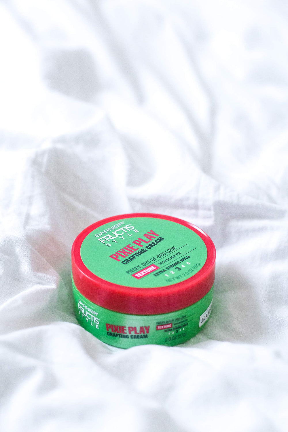 Garnier Fructis Pixie Play cream texture close-up highlighting spreadability