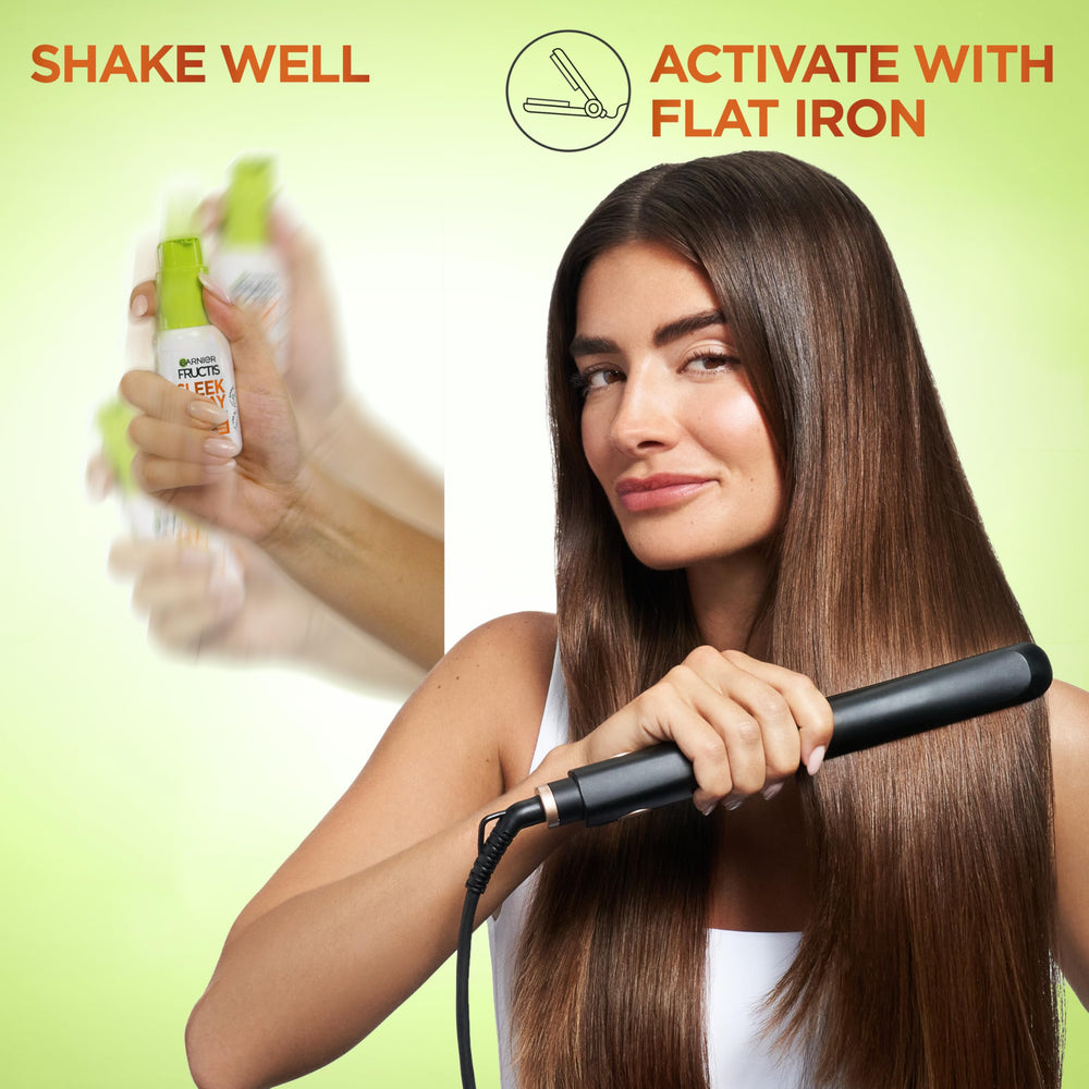 Garnier Fructis bottle next to hand for size and scale convenience benefit
