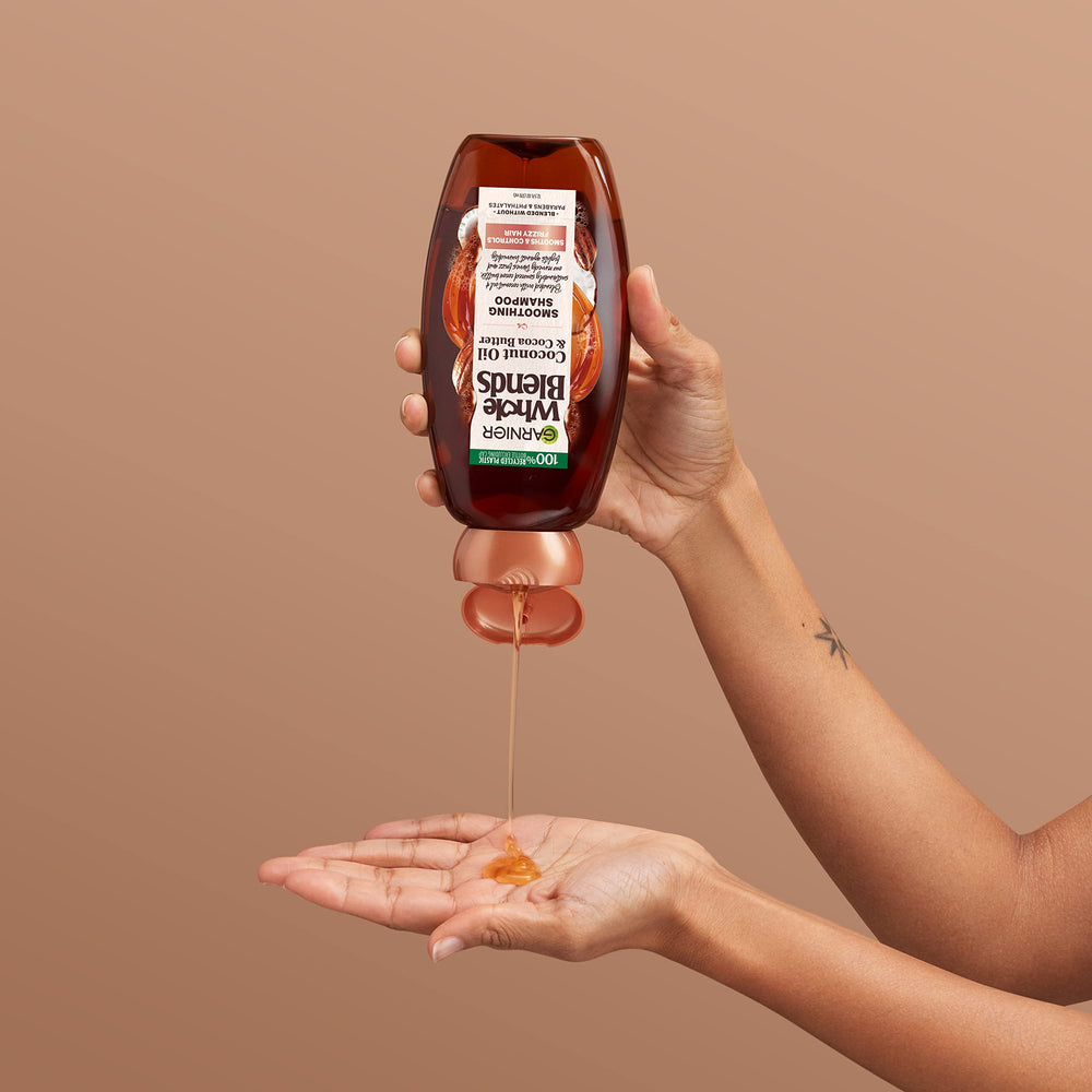Garnier bottle beside coin for size scale and travel-friendly volume clarity