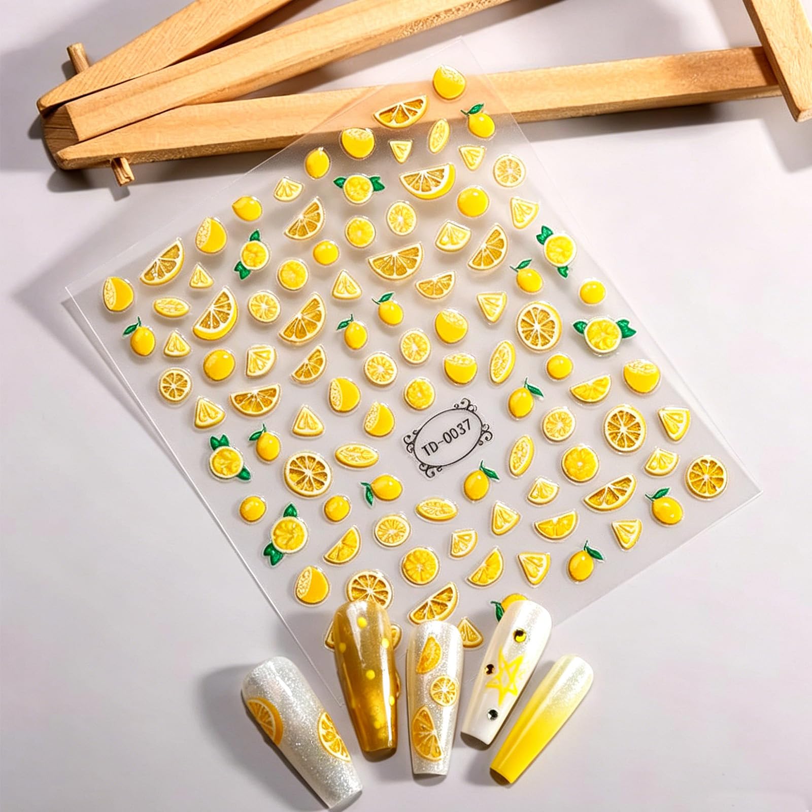 GCSQW lemon sticker applied to acrylic nail demonstrating polished finish and lively design