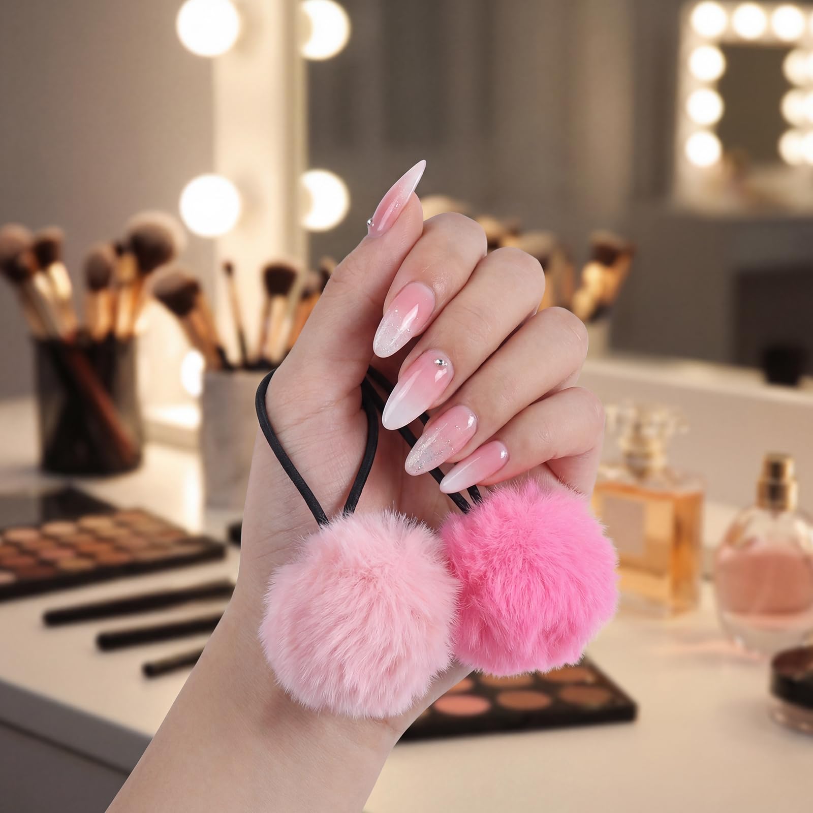 Gegraterwa pom pom next to a hand showing accurate 2-inch size