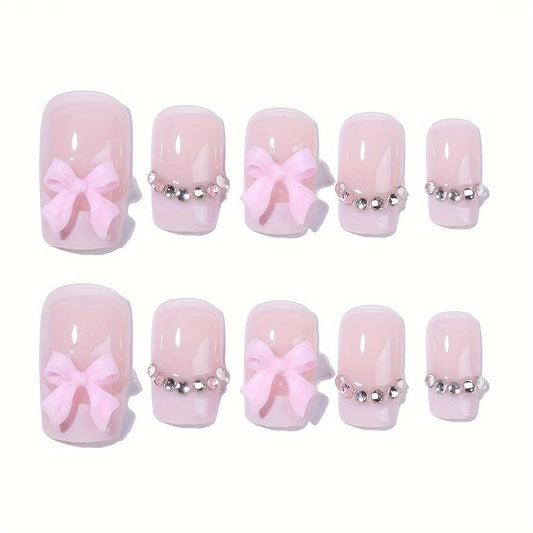 Generic close-up of rhinestone and bow detail on nail, adds sparkle and charm