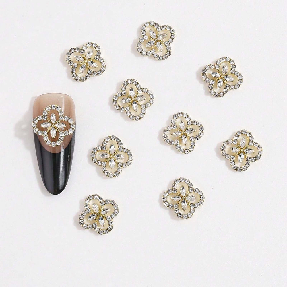 Generic hand wearing clover charms in a manicure showing Generic glamorous effect