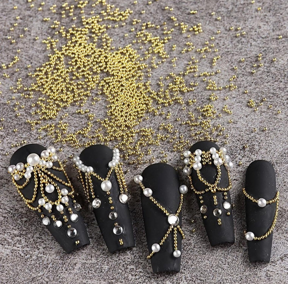 Generic manicure with gold beads demonstrating decorative 3D accent