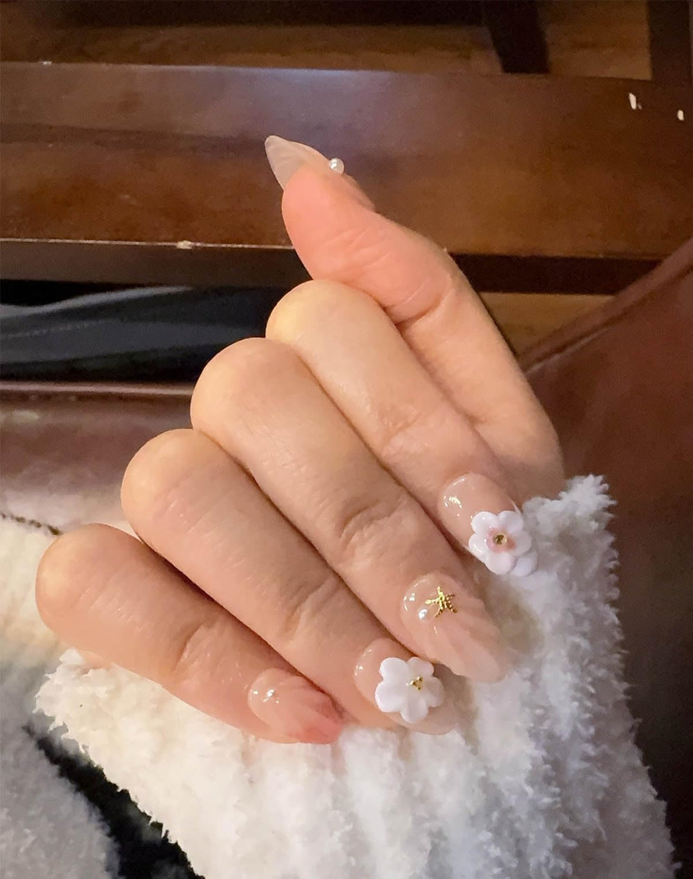 Generic hand wearing Ocean A04 nails in lifestyle setting showing photo-ready style benefit