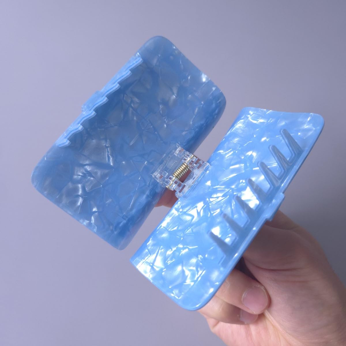 Generic sardine can clip teeth closeup highlighting long-toothed grip for security