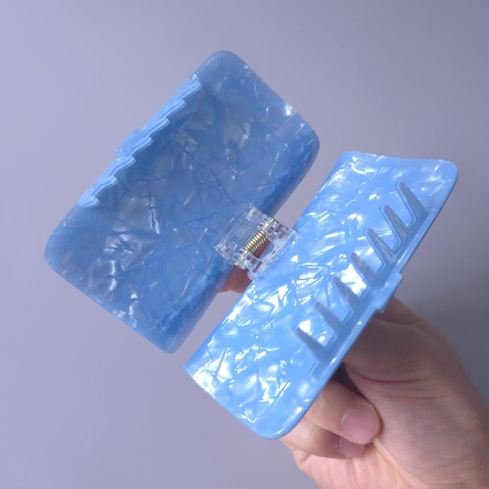 Generic sardine can clip teeth closeup highlighting long-toothed grip for security