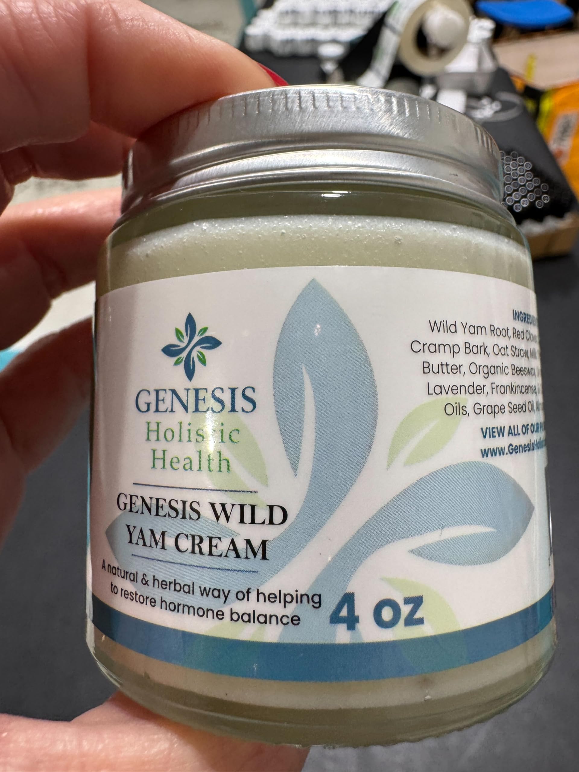 Genesis Holistic Health product being applied to inner wrist demonstrating targeted topical use