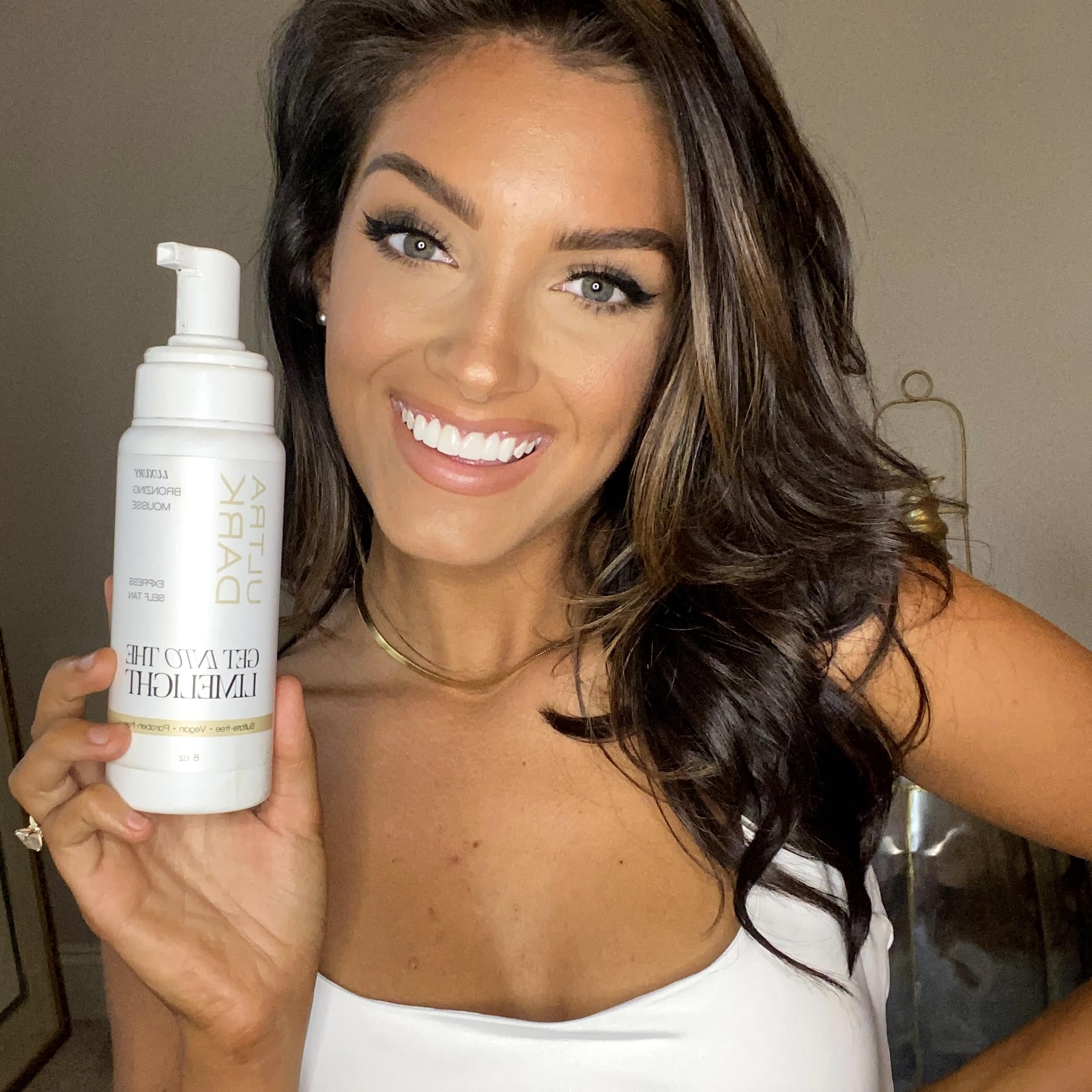 Get Into The Limelight mitt applying mousse showing even coverage and streak-free benefit