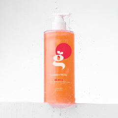 Ginger Milk Natural Care 8 oz bottle next to a ruler showing size and travel-friendly benefit