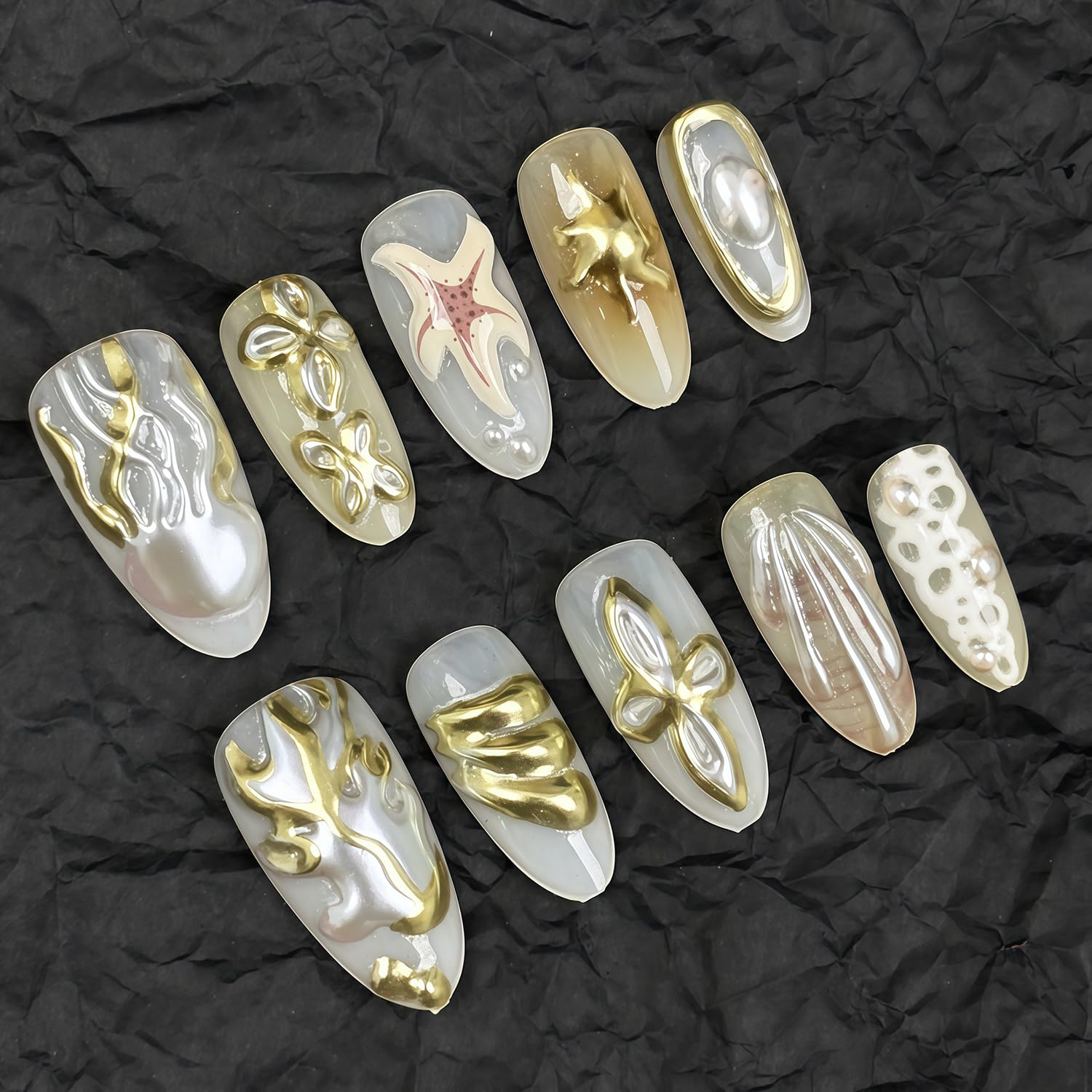 GJJBQTT hands wearing long almond press-on nails showing finished salon look