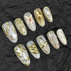 GJJBQTT hands wearing long almond press-on nails showing finished salon look
