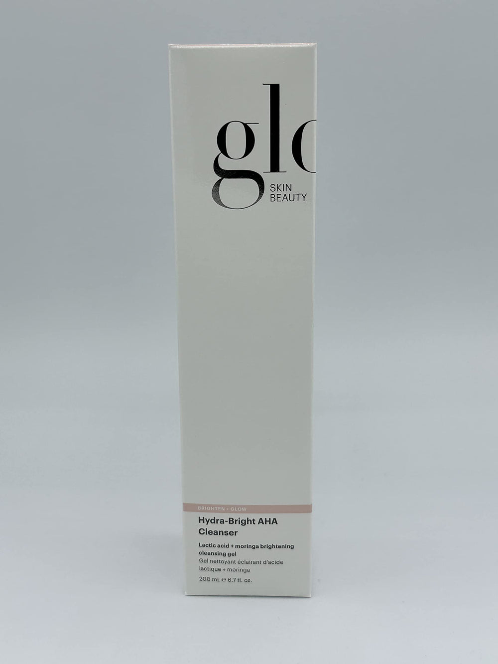 Glo Skin Beauty bottle held in hand showing 6.7 oz scale for travel and storage