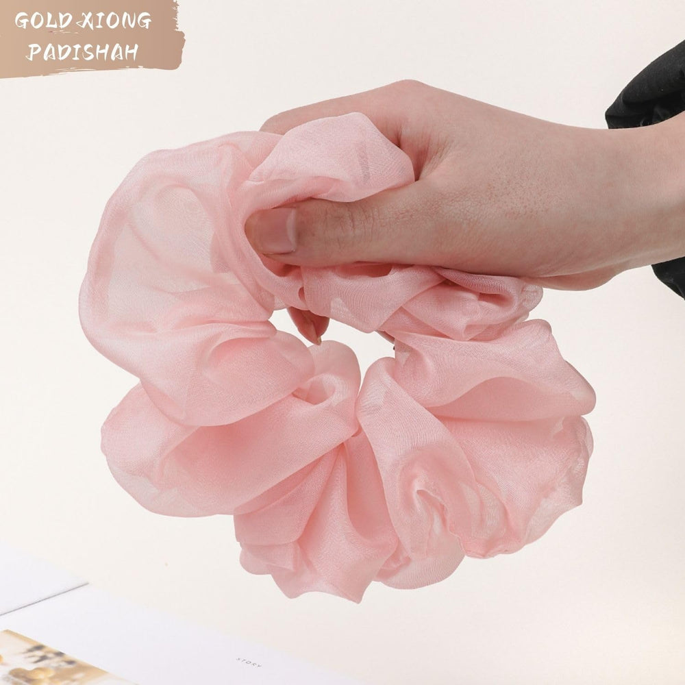 GOLD XIONG PADISHAH scrunchie worn on wrist as accessory and quick hair backup