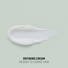 Goldwell cream in hand close-up showing creamy texture and moisture for defined curls