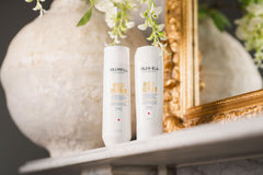 Goldwell Dualsenses bottle on bathroom shelf styled scene showing daily routine benefit