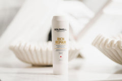 Goldwell Dualsenses bottle next to a ruler for scale showing 1L capacity benefit