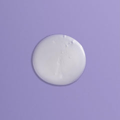Goldwell Just Smooth bottle on bathroom shelf in styled setting for salon-quality routine