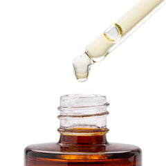 Good Molecules 1 fl oz bottle next to a coin for scale showing travel-friendly size