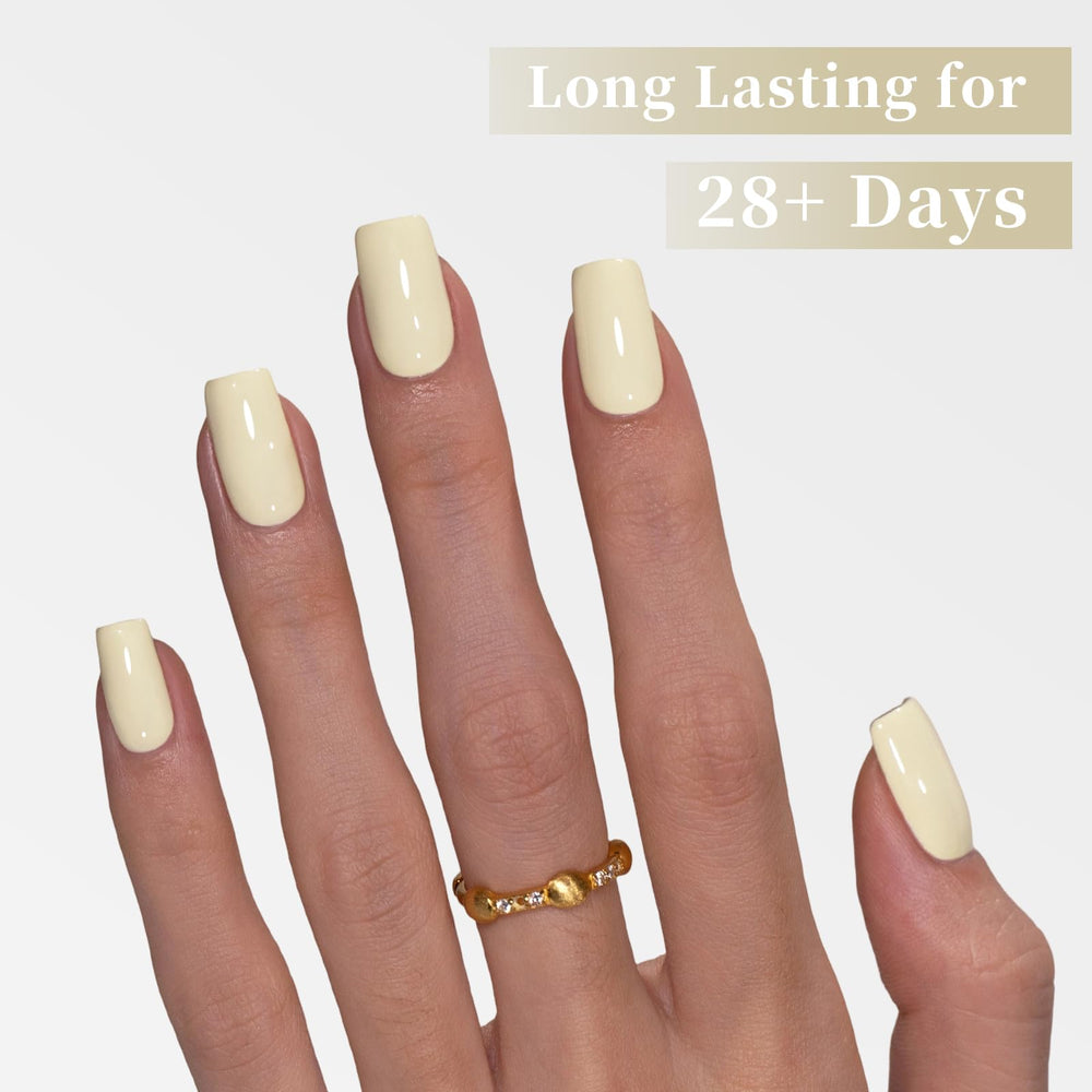 Goolich nail swatch on hand demonstrating glossy pastel yellow manicure durability