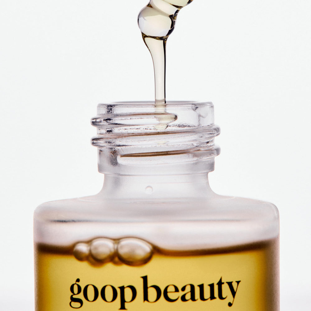 goop nutrient face oil bottle scale with hand illustrating compact one‑ounce size