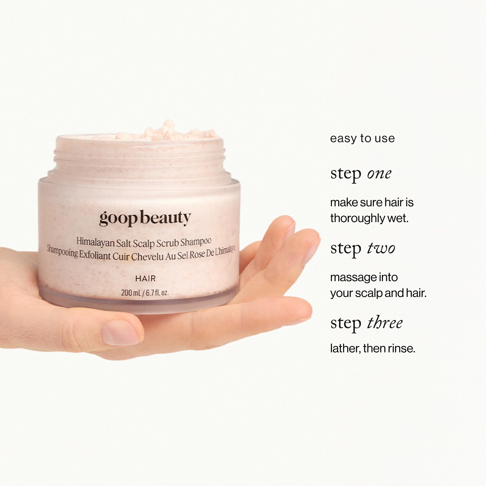 goop bottle in hand demonstrating 6.7 fl oz size and portability