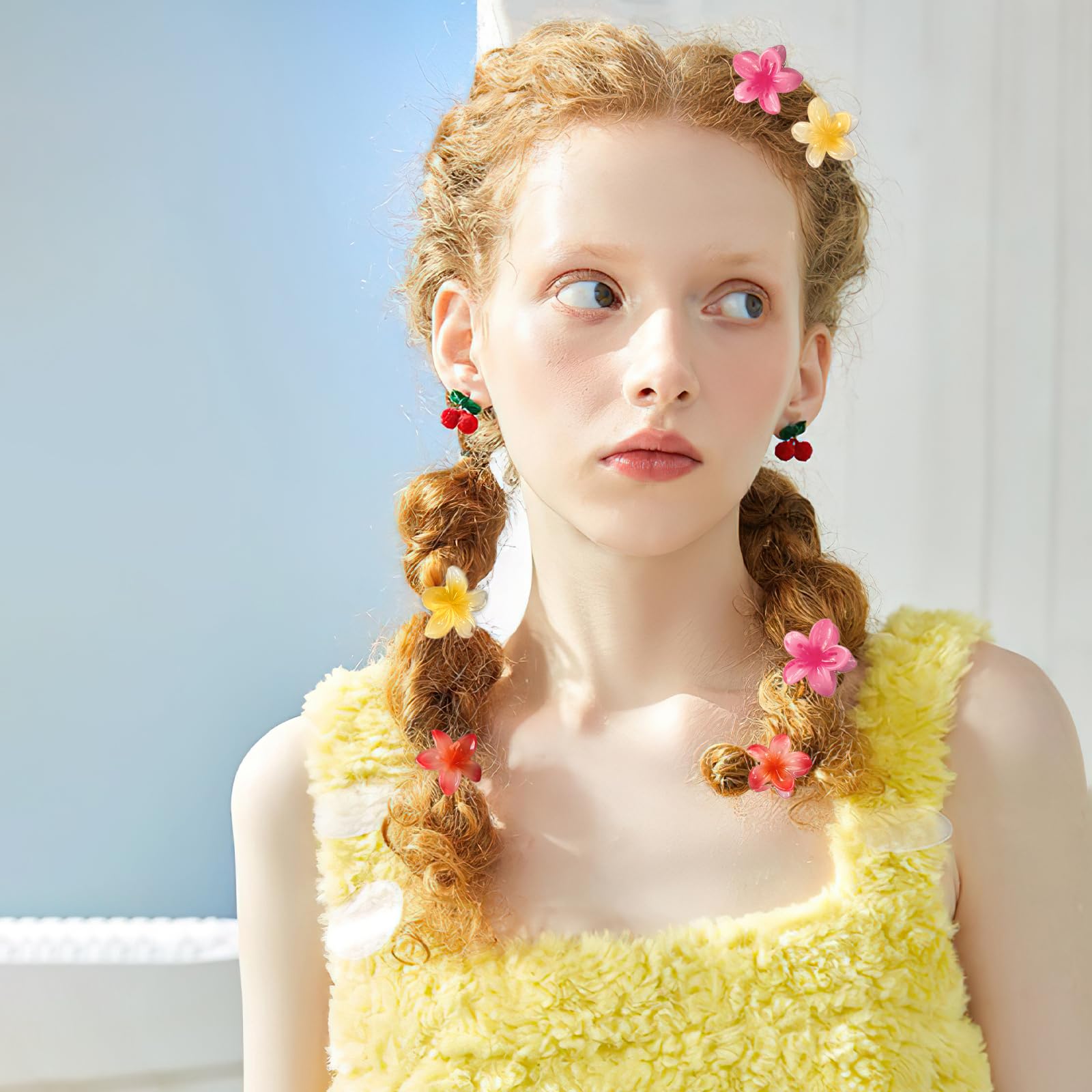 GQLV in hair bangs style securing fringe with a bright floral accent
