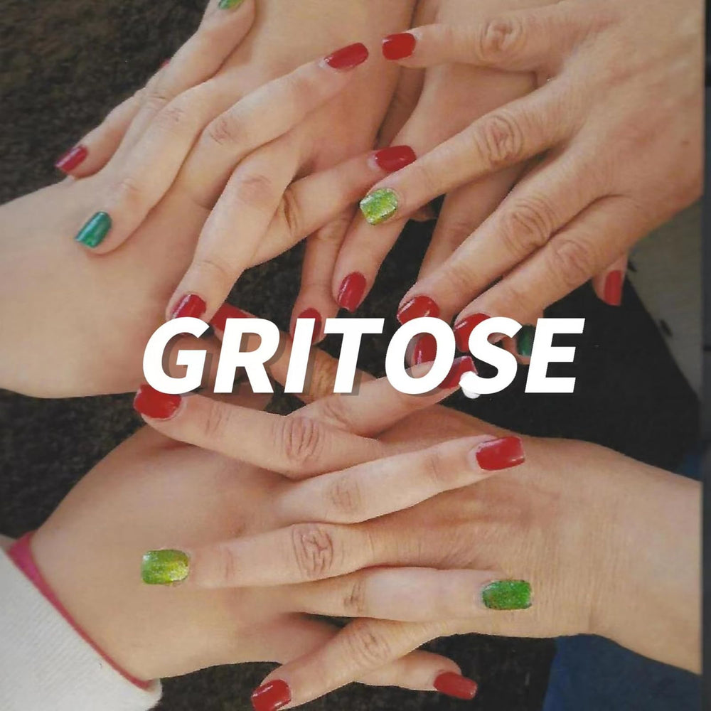 GRITOSE nails worn on hands at Halloween party, striking red-black manicure impact