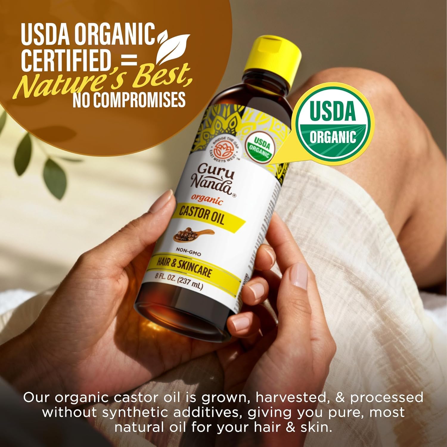 Heap of castor seeds with GuruNanda bottle, highlighting natural source benefit