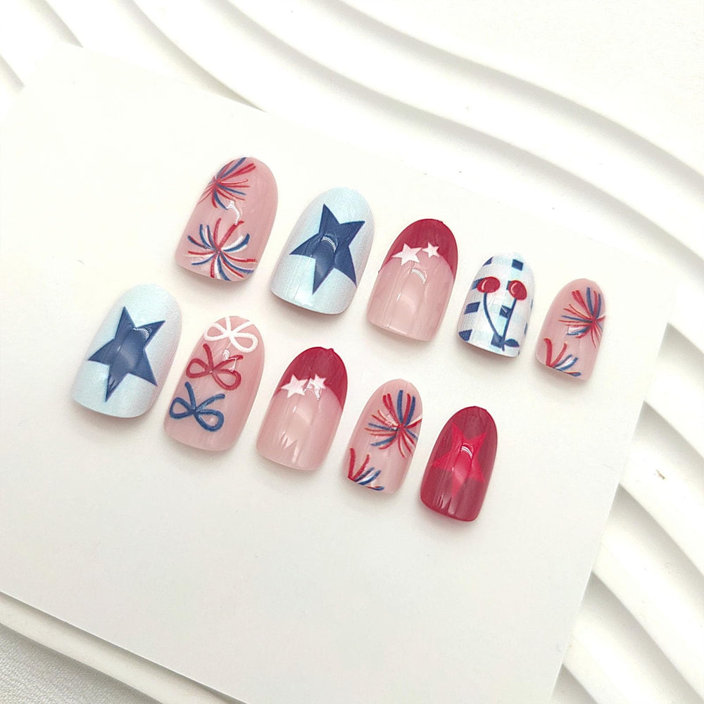 GXOIPNS close-up of bow, star and fireworks nail art showcasing glossy festive detail