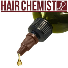 flatlay with bottle and botanicals by Hair Chemist showing natural ingredients