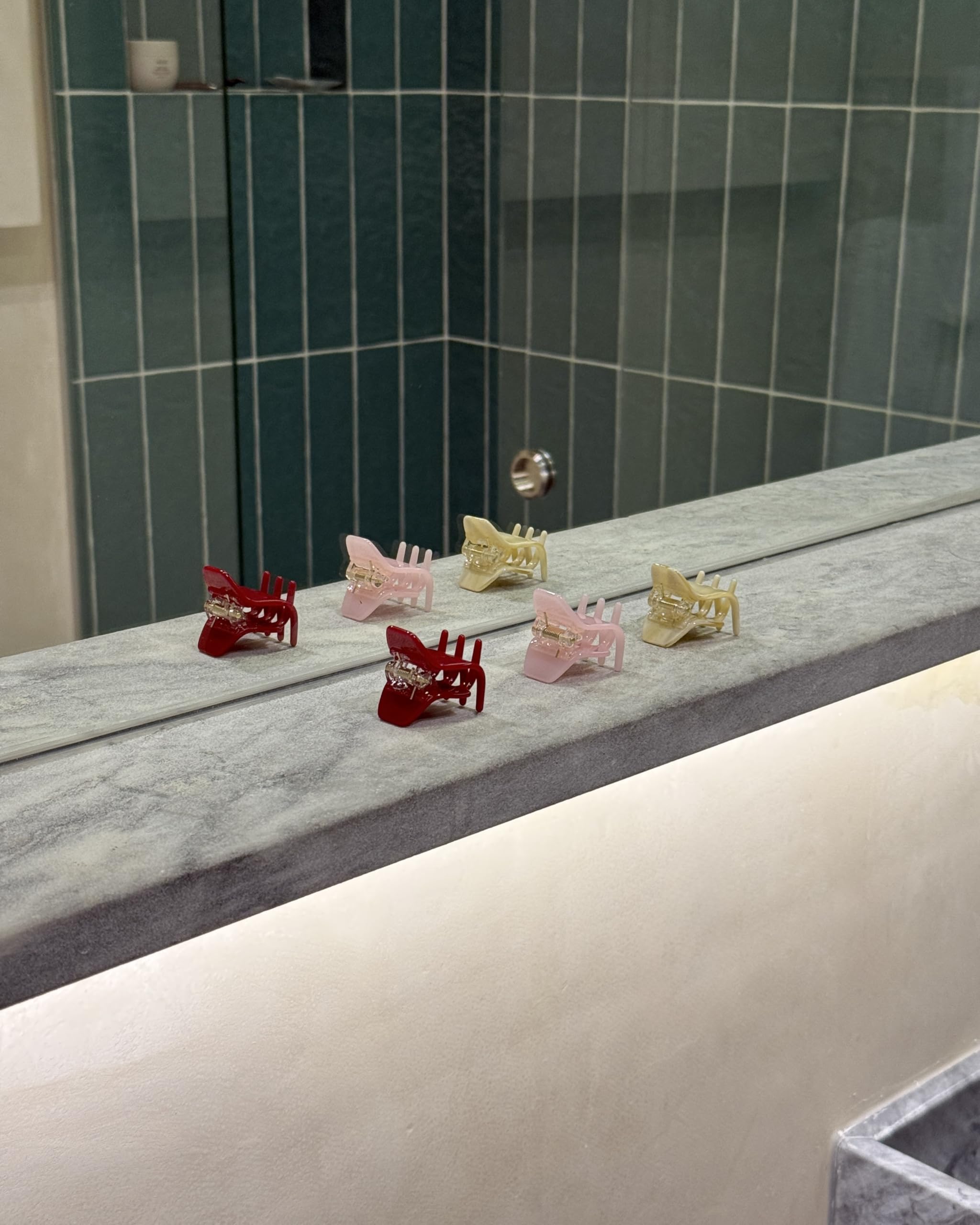 Hana Mia clip held in hand to show 1-inch scale and lightweight benefit
