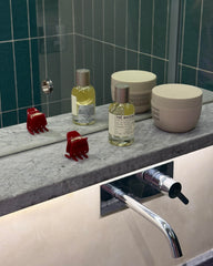 Hana Mia clip in hand to show 1-inch scale and lightweight convenience