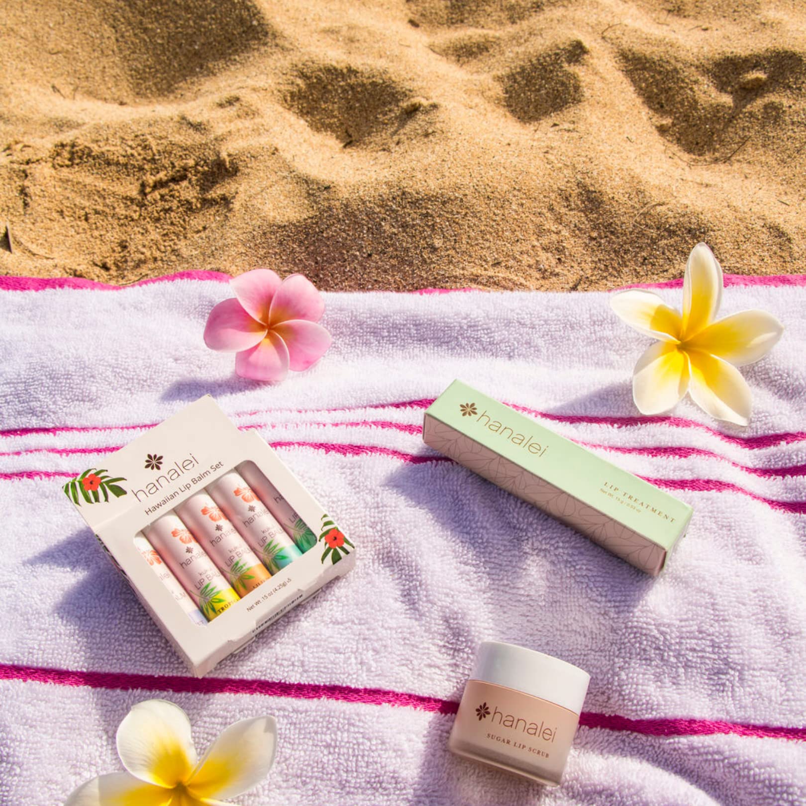 Hanalei lip balm on a beach towel illustrating travel-ready hydration