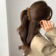Hapdoo clip used to create a low bun for neat everyday looks