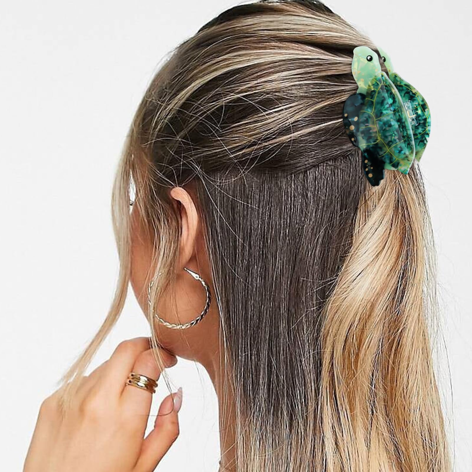 Hapdoo sea turtle in hair demo holding medium hair in a half-up style with flair