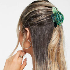 Hapdoo sea turtle in hair demo holding medium hair in a half-up style with flair
