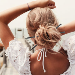 Hariendny hair sticks securing a bun for stable elegant updo look